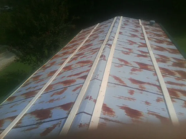 Rusted metal roof panels with new wood purlins before replacement — Storm Damage Roof Repair in Vernon Hills by Roofing Brothers